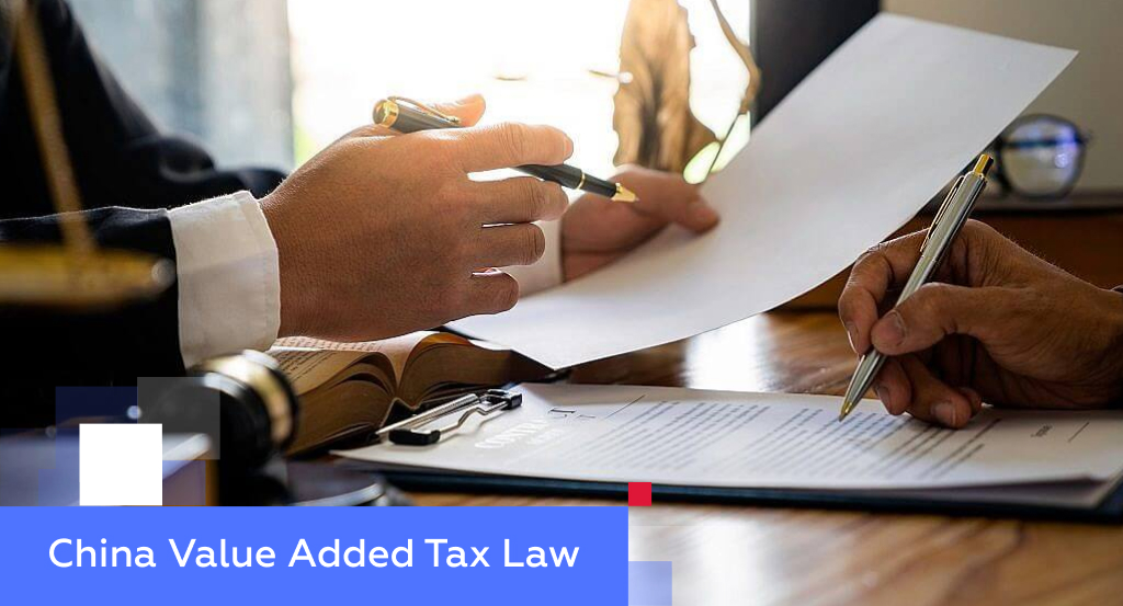 Two professionals reviewing and signing a tax document — illustrating China’s Value Added Tax (VAT) Law
