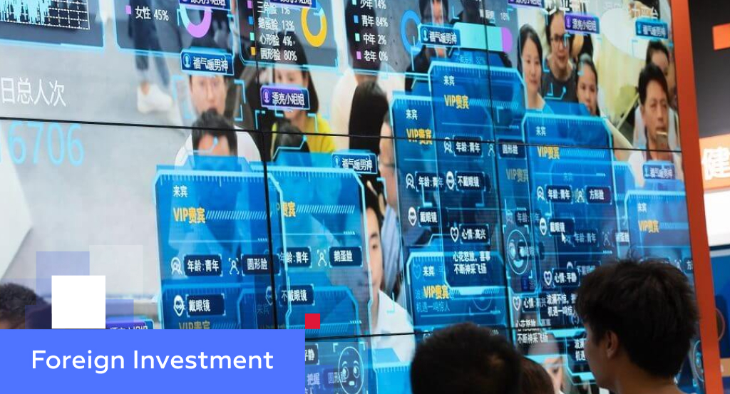 People watching an AI facial-recognition demographic display in Chinese — illustrating encouraged industries for foreign investment in China